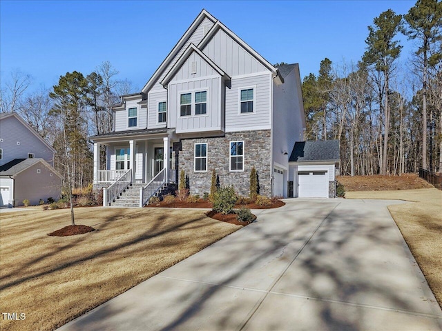 view of front of house featuring a porch, a front yard, and a garage