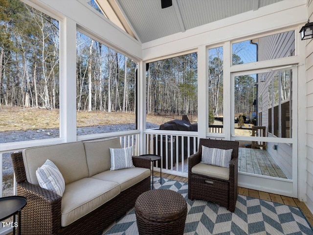 sunroom featuring lofted ceiling