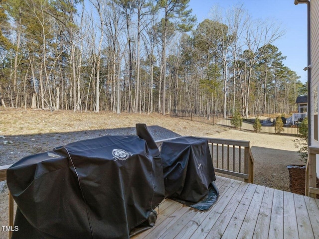 wooden terrace featuring a grill