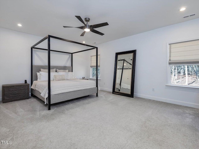 bedroom with ceiling fan and light carpet