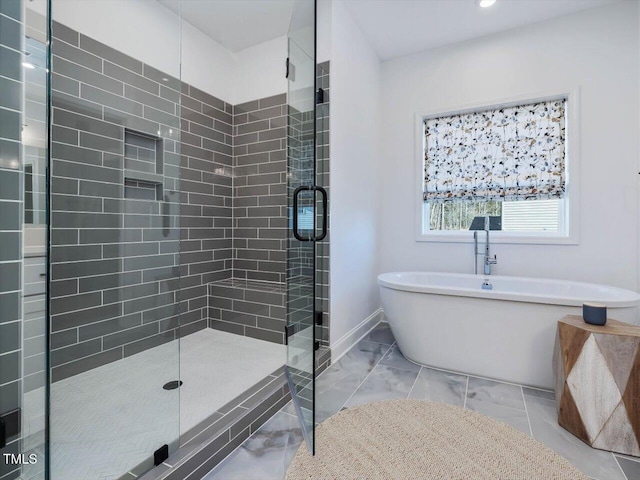 bathroom featuring shower with separate bathtub