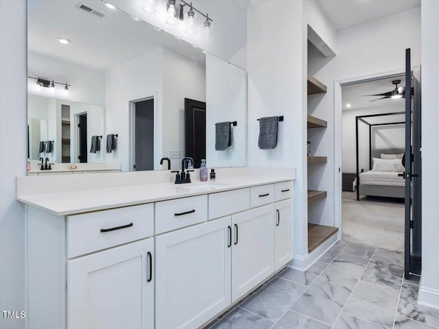 bathroom with vanity, ceiling fan, and built in shelves