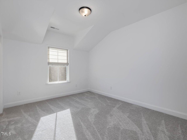 bonus room featuring vaulted ceiling and carpet