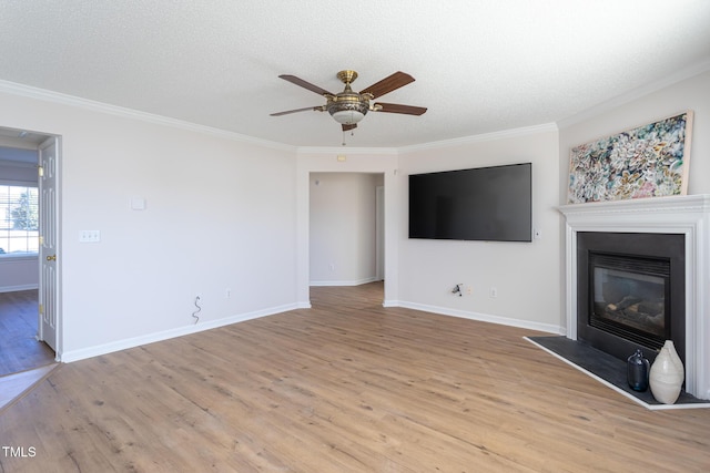 unfurnished living room with a textured ceiling, ceiling fan, crown molding, and light hardwood / wood-style flooring