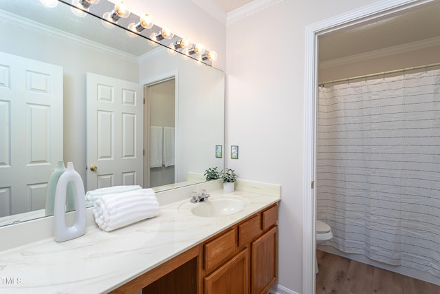 bathroom with wood-type flooring, vanity, toilet, a shower with shower curtain, and crown molding