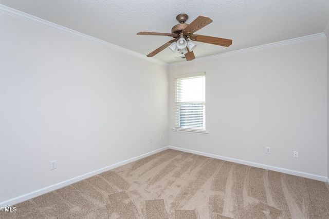 carpeted empty room with ceiling fan, ornamental molding, and a textured ceiling