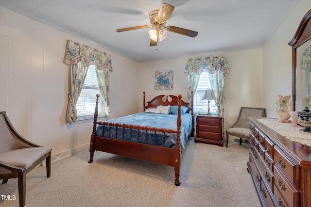 bedroom with ceiling fan, crown molding, and light colored carpet