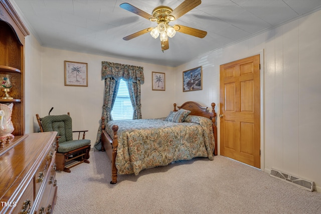 bedroom with light carpet, ceiling fan, and crown molding