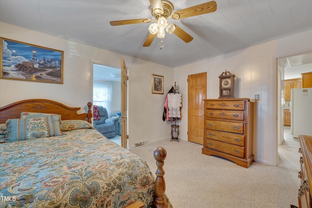 bedroom with white refrigerator, ceiling fan, and light carpet