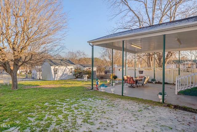 view of yard featuring a patio and a shed