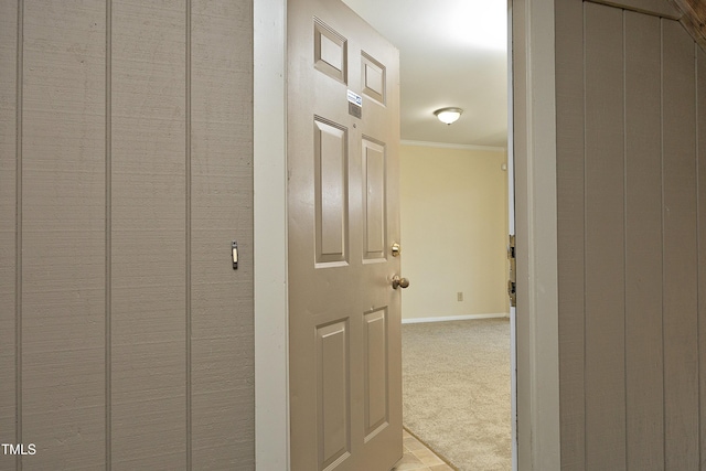 hallway with light carpet and crown molding