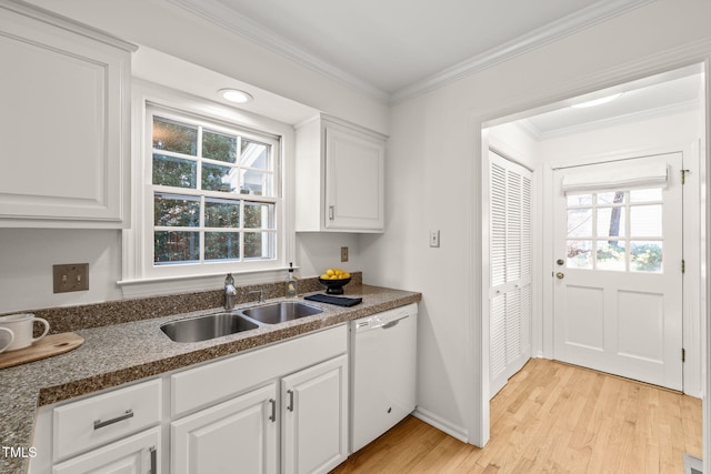 kitchen featuring sink, white cabinets, white dishwasher, and light hardwood / wood-style flooring