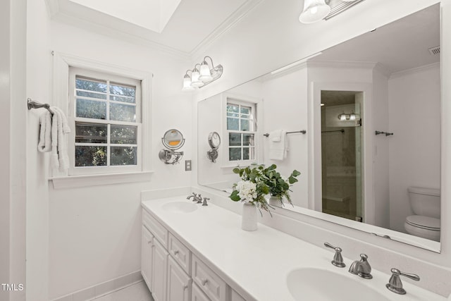 bathroom featuring vanity, ornamental molding, and toilet