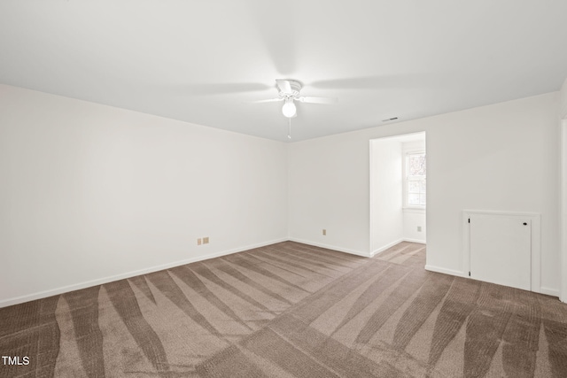 unfurnished room with ceiling fan and light colored carpet