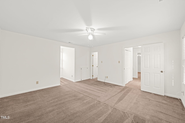 unfurnished room featuring ceiling fan and light carpet