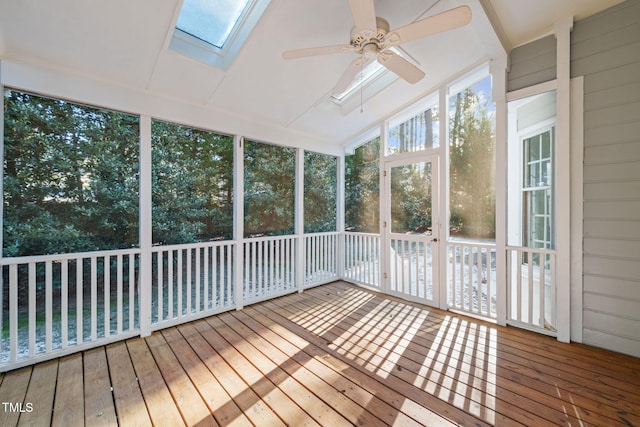 unfurnished sunroom with ceiling fan and lofted ceiling with skylight