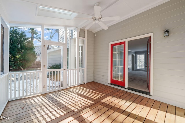 unfurnished sunroom featuring a skylight and ceiling fan