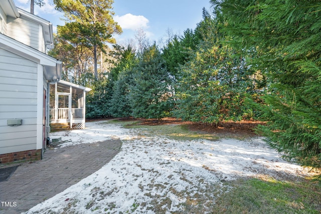 view of yard featuring a patio and a sunroom