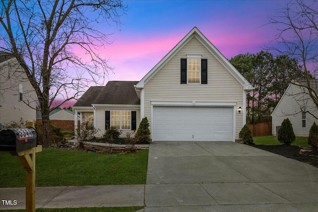 front of property with a yard and a garage