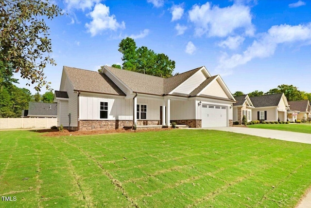 view of front of property with a front yard and a garage