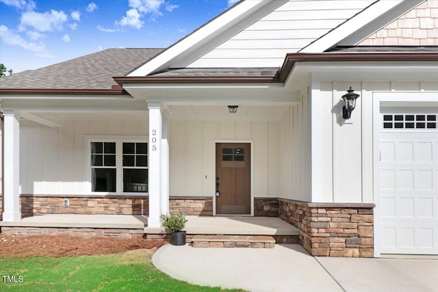 entrance to property with covered porch and a garage