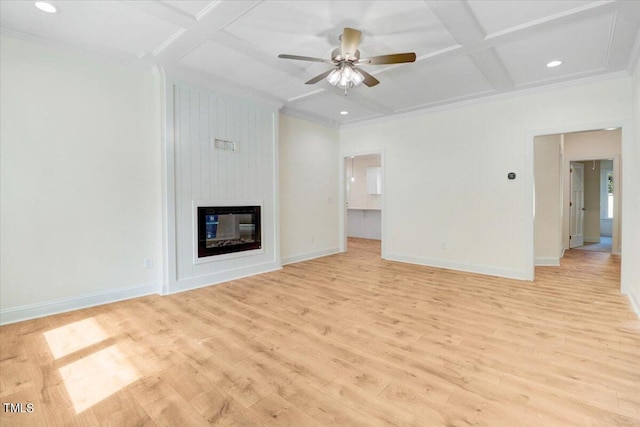 unfurnished living room featuring ornamental molding, light wood-type flooring, coffered ceiling, and a fireplace