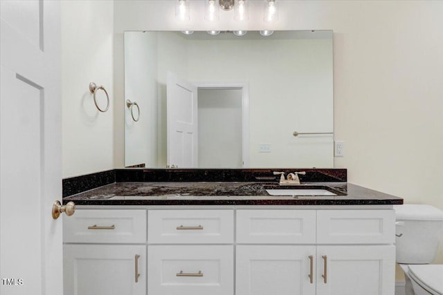 bathroom with toilet and vanity