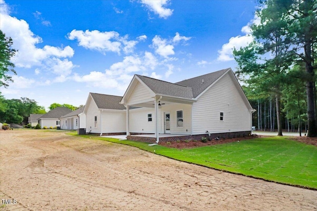 view of property exterior with a patio area and a yard