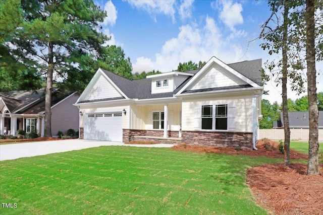 craftsman inspired home with a garage and a front lawn