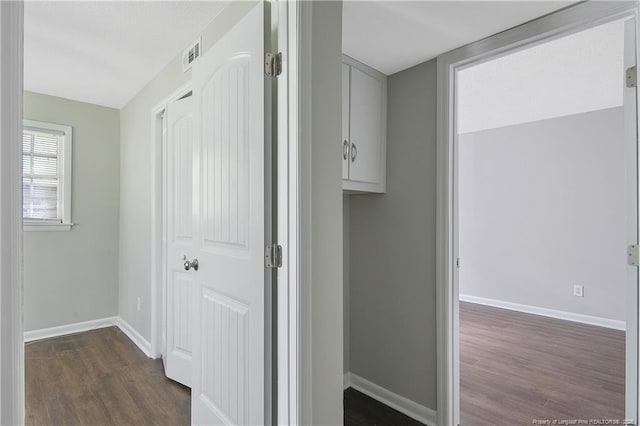 hallway with dark wood-type flooring