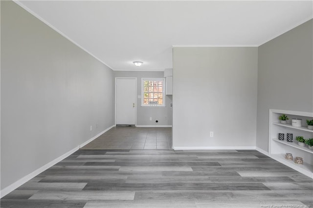 empty room featuring hardwood / wood-style floors and ornamental molding