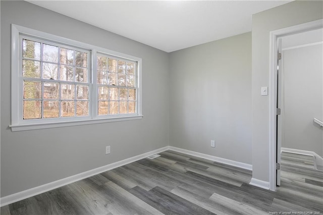 spare room featuring dark hardwood / wood-style floors