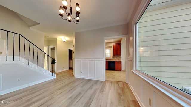 interior space with ornamental molding, light wood-type flooring, and a chandelier