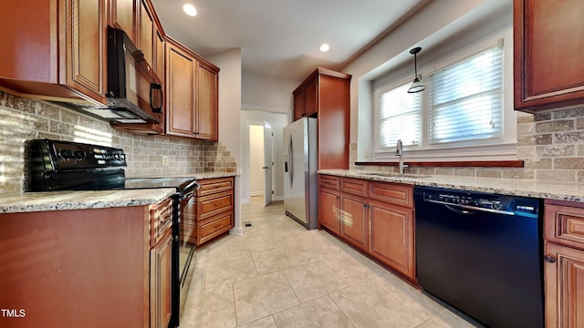 kitchen featuring light stone countertops, hanging light fixtures, black appliances, light tile patterned flooring, and sink