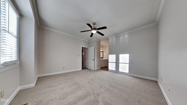 empty room featuring a textured ceiling and plenty of natural light