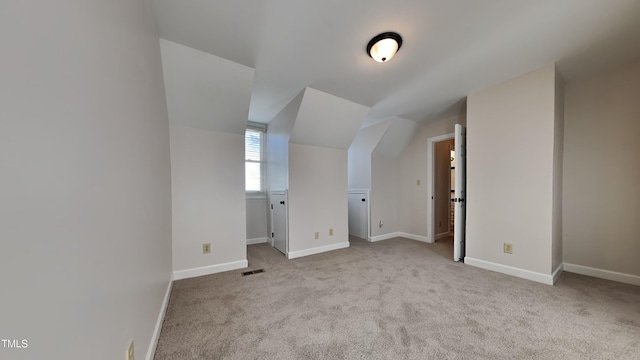 bonus room with light carpet and lofted ceiling