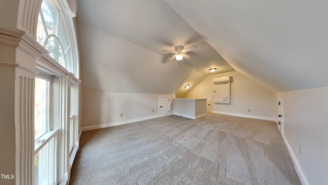 additional living space featuring lofted ceiling, light colored carpet, a wall unit AC, and ceiling fan