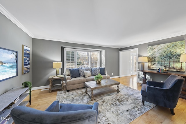 living room featuring ornamental molding and light hardwood / wood-style floors