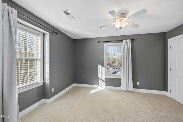 empty room featuring light carpet and ceiling fan