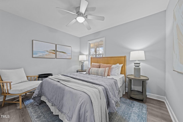 bedroom with hardwood / wood-style flooring and ceiling fan