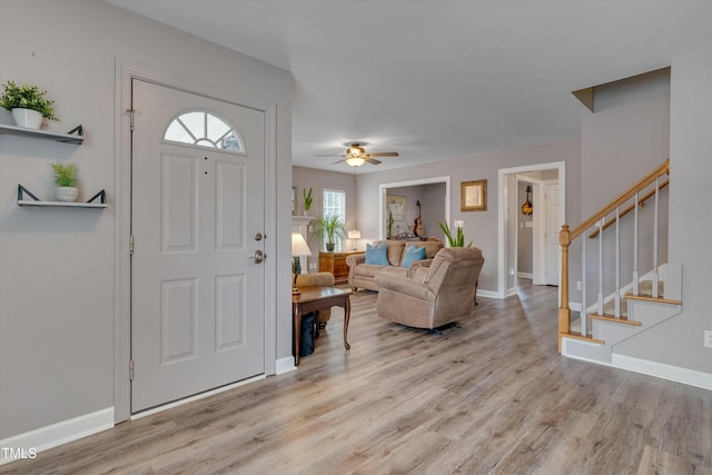 foyer entrance with ceiling fan, light wood-type flooring, and plenty of natural light