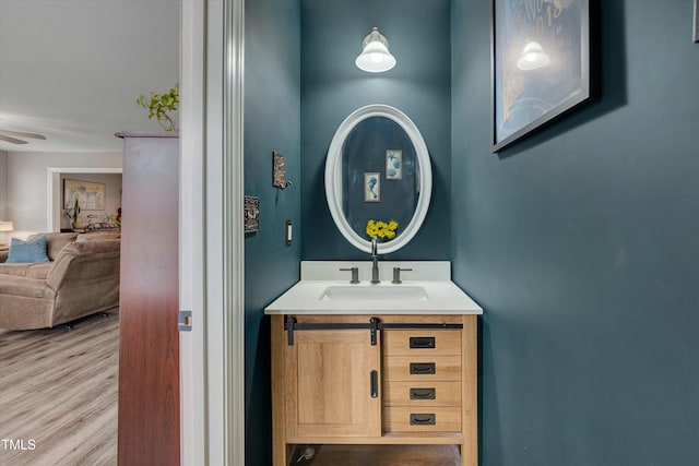 bathroom featuring ceiling fan, hardwood / wood-style flooring, and vanity