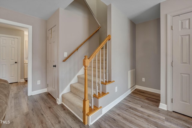 staircase with wood-type flooring