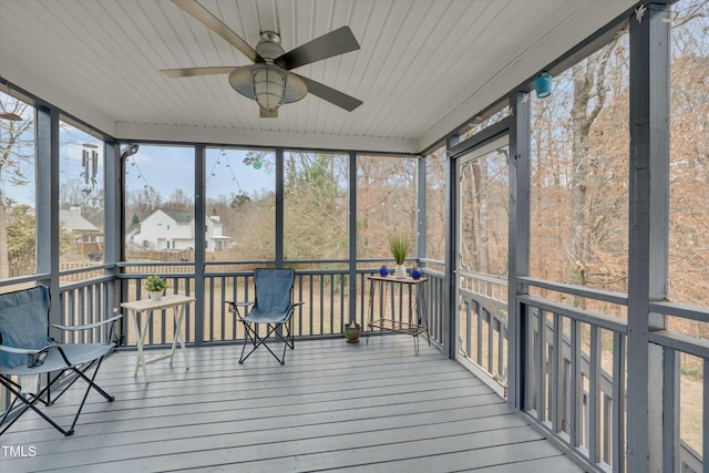 unfurnished sunroom with ceiling fan