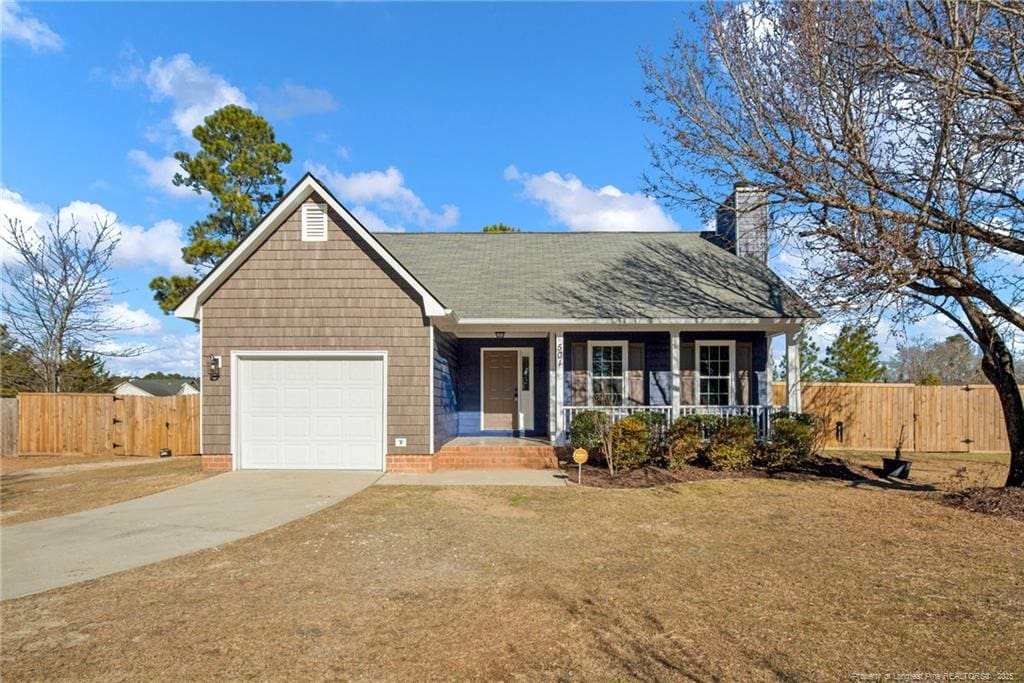 ranch-style home with covered porch and a garage