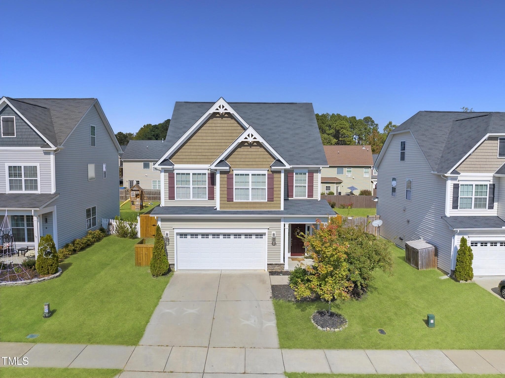 view of front of home featuring a garage and a front lawn