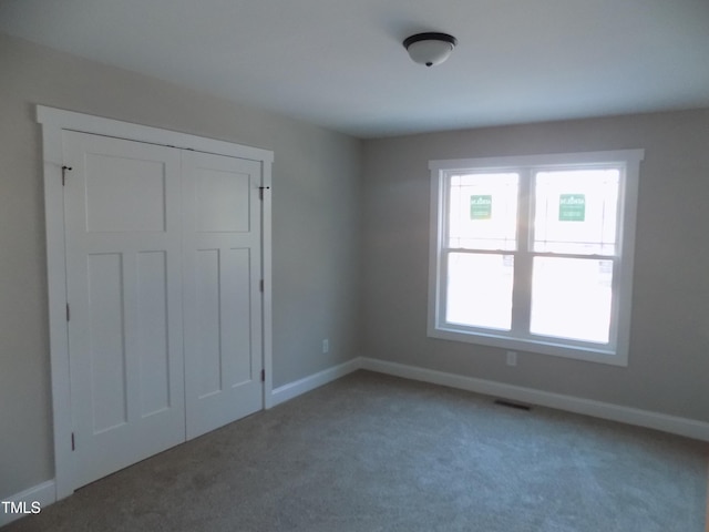 unfurnished bedroom featuring a closet and carpet