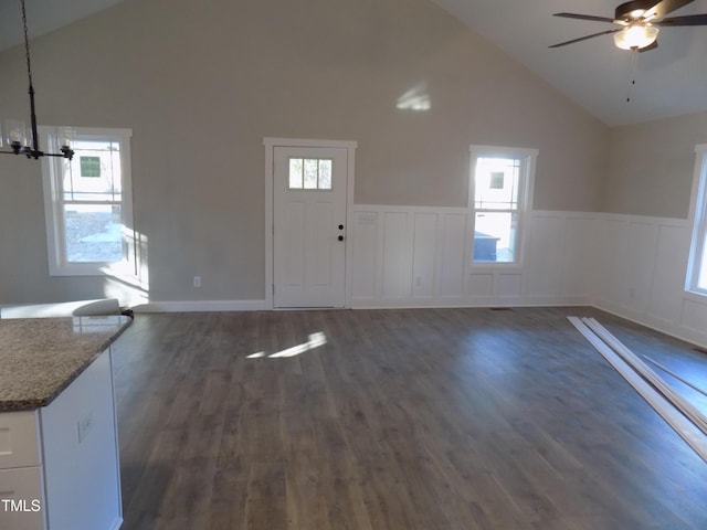 foyer with ceiling fan, dark wood-type flooring, and high vaulted ceiling