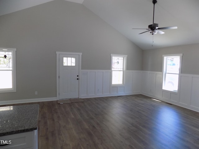 104 Halifax Rd, Louisburg, NC 27549 - unfurnished living room featuring dark wood finished floors, a healthy amount of sunlight, a wainscoted wall, and high vaulted ceiling