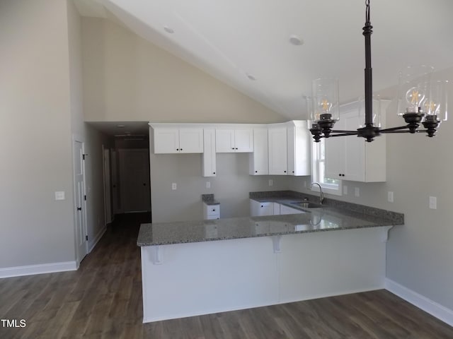 104 Halifax Rd, Louisburg, NC 27549 - kitchen with a sink, stone countertops, baseboards, white cabinets, and a peninsula